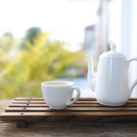 Elegant Vintage White Ceramic Tea Pot on Wooden Table Top Down Classic View