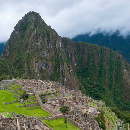 Enchanting View of Machu Picchu Amidst Lush Green Peaks