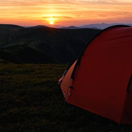 Evening Camping in the Mountains Dramatic Sunset Adventure with a Tourist Tent