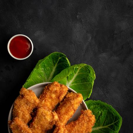 Falling Nuggets on Isolated White Plate