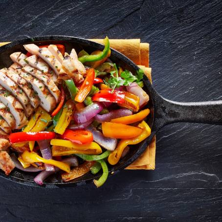 Flavorful Grilled Chicken and Vegetables on Rustic Wooden Table