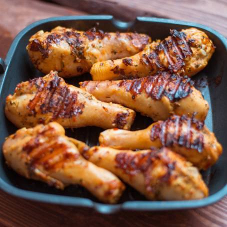 Floating BBQ Chicken Drumsticks with Spices and Vegetables, Spicy Grilled Legs with Herbs