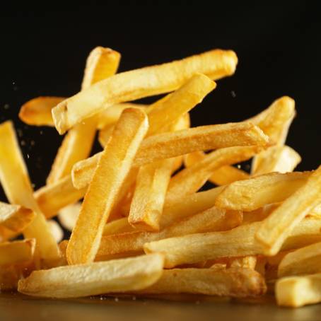 Flying French Fries in Air Isolated on White Background, Potato Chips Floating, Fast Food