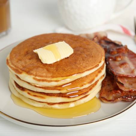 Fresh Pancakes with Syrup and Butter on White Plate, Isolated