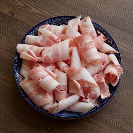 Fresh Raw Pork Belly Slices on Black Plate, Top View for Culinary Use