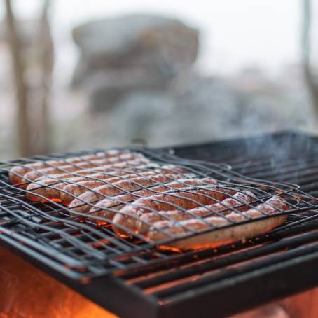 Fresh Rosemary Grilled Sausage on Hot Barbecue Plate  Delicious BBQ Treat