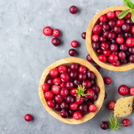 Full Depth of Field Cranberries with Leaves on White Isolated Top View of Juicy Berries