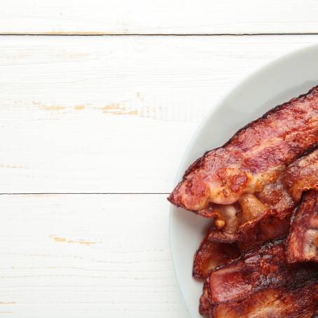 Golden Bacon Slice Isolated on White Background