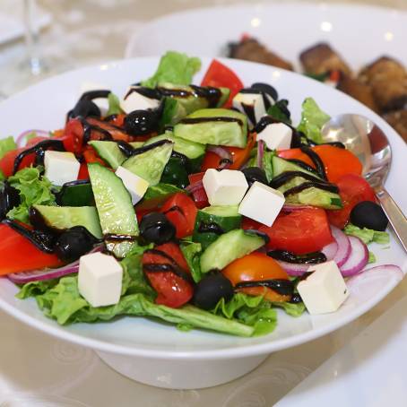 Greek Salad Fresh Vegetables and Cheese Isolated on White