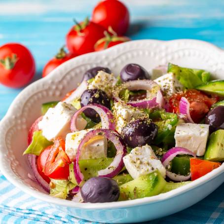 Greek Salad with Cheese and Fresh Vegetables Isolated on White Surface