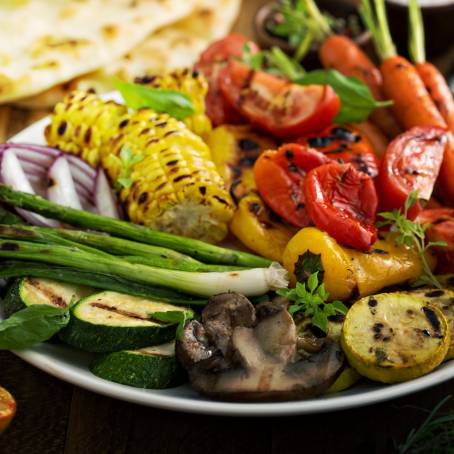 Grilled Chicken and Mixed Vegetables on Wooden Table Surface