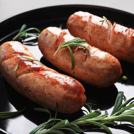 Grilled Sausage with Fresh Rosemary on Hot Barbecue Dish  Perfect Summer Meal