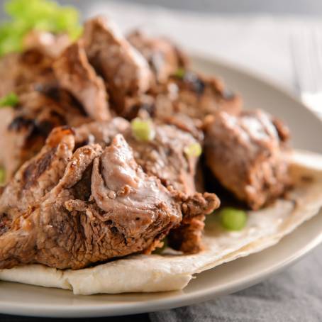 Grilled Shish Kebab Pieces with Fresh Green Salad on White Plate Perfect for a Healthy Meal