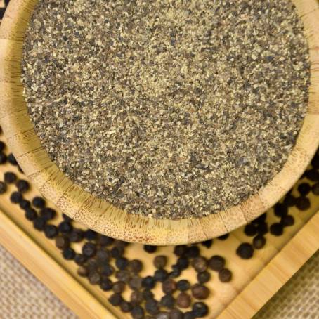 Ground Pepper and Peppercorns Close Up in Wooden Dish