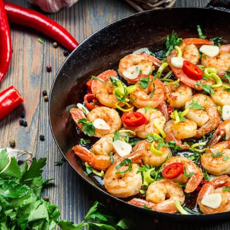 Herb Seasoned Shrimps in Pan with Citrus Zest and Fresh Ingredients