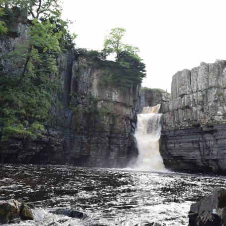 High Force waterfall in full flow, surrounded by nature beauty