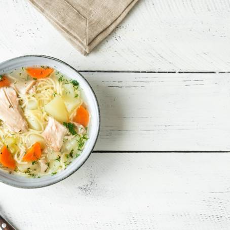 Homemade Chicken Noodle Soup Broth Isolated on White, Warm Comfort Food, Savory and Classic