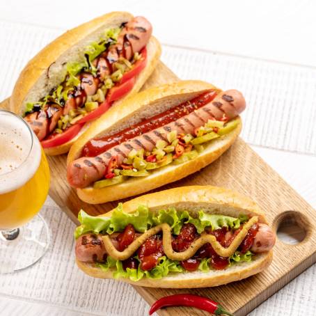 Hot Dog with Mustard and Ketchup, Served with Beer on Table