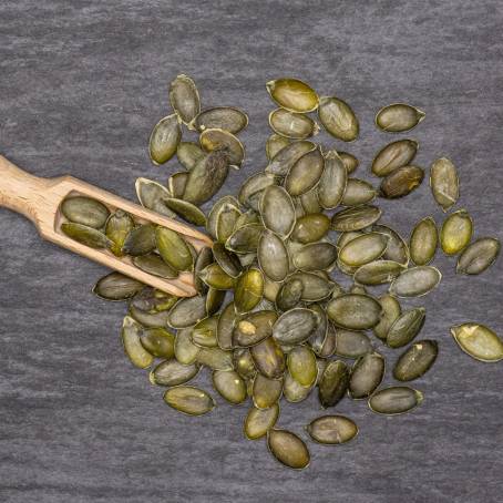 Hulled Pumpkin Seeds on White Surface Isolated Healthy Snack