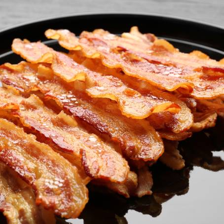 Isolated Crispy Fried Bacon Slice on Plain White