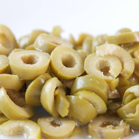 Isolated Green Olives and Slices Flying on White