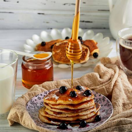 Isolated Honey Drizzled Pancakes on White