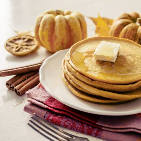 Isolated Plate of Pancakes with Butter and Syrup on White