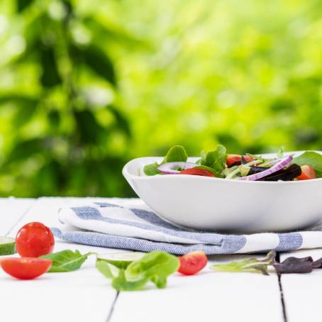 Isolated Salad Bowl with Spinach, Cherry Tomatoes, Lettuce, Cucumber and More Vegetables