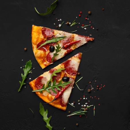 Italian Pizza Slices with Pepperoni, Cheese, and Basil Flying in Air Delicious and Isolated