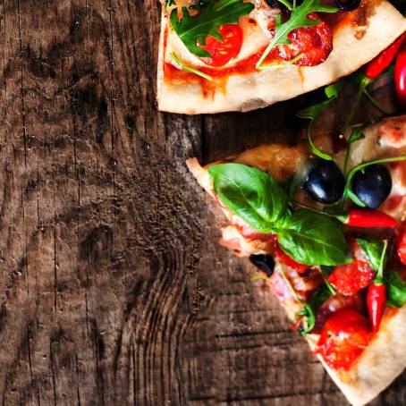 Italian Pizza Slices with Pepperoni, Cheese, and Basil Flying in Air Isolated on White Background