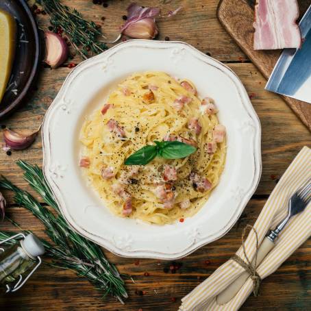 Italian Spaghetti Carbonara with Cream Sauce on White Plate, Selective Focus