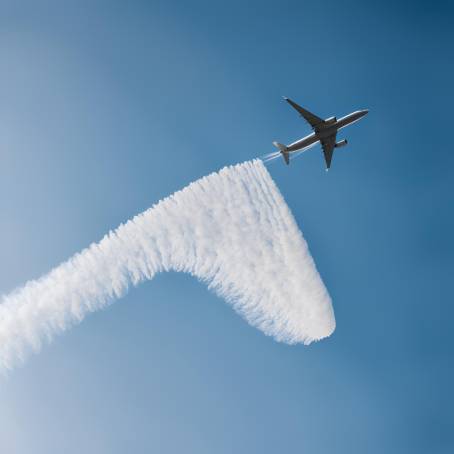 Jet Aircraft Contrail in Clear Blue Sky High Altitude Stream of Ice Crystals