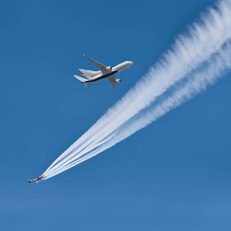 Jet Aircraft Leaving Contrail in Clear Blue Sky Ice Crystal Formation from Exhaust