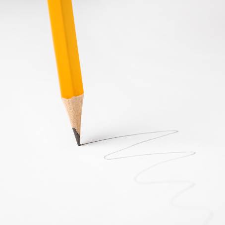 Macro Photography of Broken Pencil Tip and Graphite on Red Background