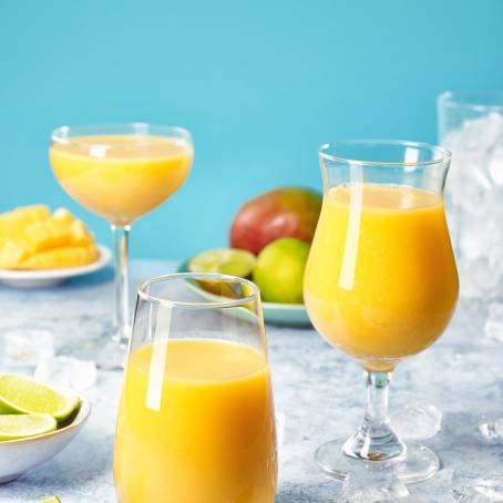 Mango Smoothie with Fresh Fruit in Tall Glasses for a Refreshing Drink