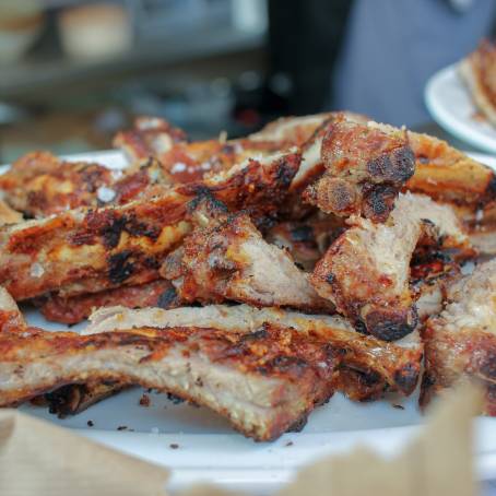 Mouthwatering Smoked Ribs with Sweet Barbecue Sauce on a Carving Board