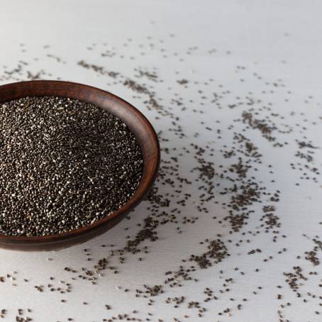 Nutrient Dense Chia Seeds in a Wooden Spoon on a Clean Surface