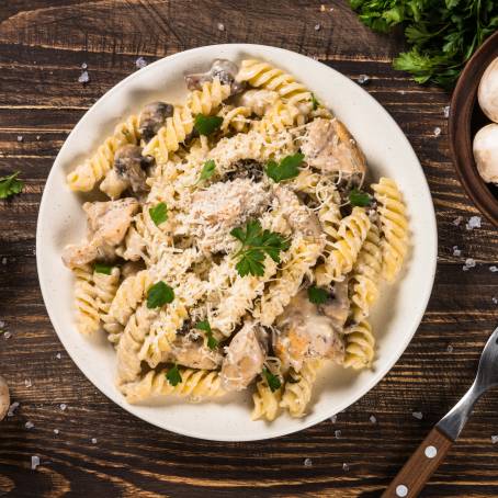 Overhead Flat Lay of Mushroom Pappardelle with Cream Sauce and Parsley