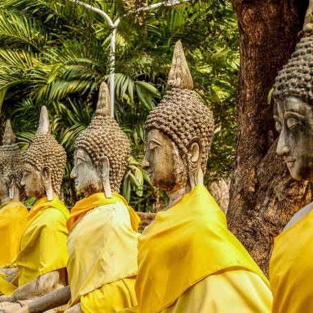 Pagoda and Buddha Statue at Wat Yai Chaimongkol Ayutthaya Ruins with Blue Sky