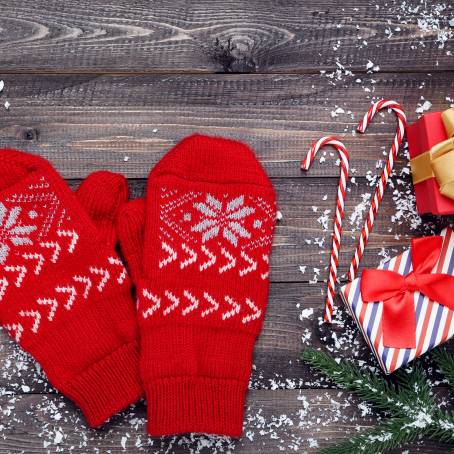 Pair of Cozy Red Knitted Mittens with Christmas Pattern Isolated on White Background