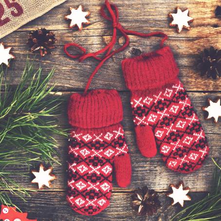 Pair of Red Christmas Mittens Knitted with Holiday Pattern Isolated on White Background