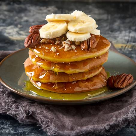 Pancakes with Syrup and Butter on a White Background