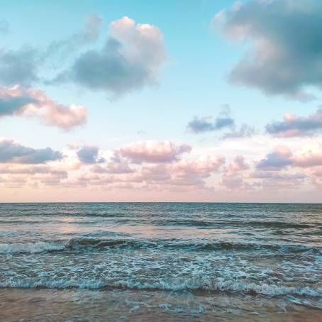 Peaceful Ocean Scene with Calm Waters and Fluffy Clouds Above