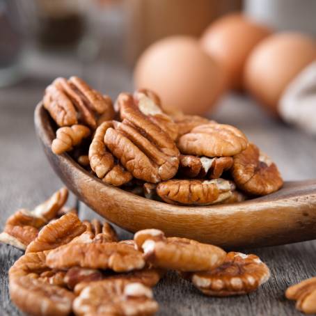 Peeled Pecans on White Plate CloseUp