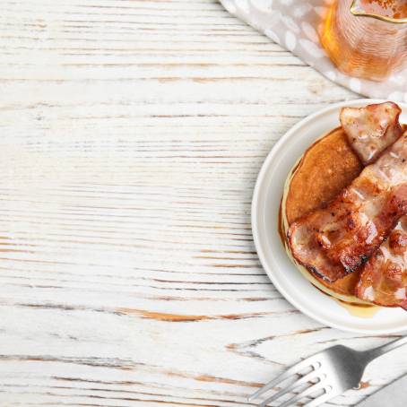 Plate of Pancakes with Syrup and Butter Isolated on White