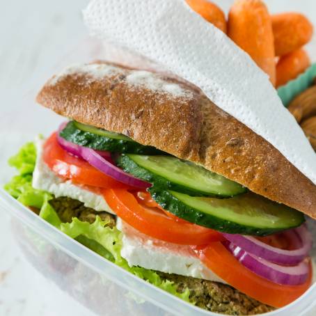 Quick and Healthy Lunch Box with Sandwich, Carrots, and Salad