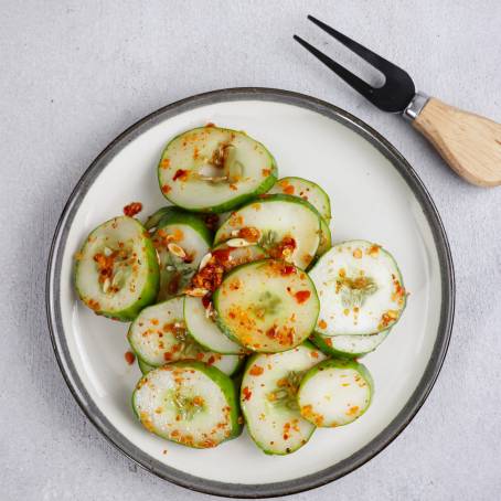 Quick Cucumber Kimchi Spicy Korean Salad on White Plate, Top View