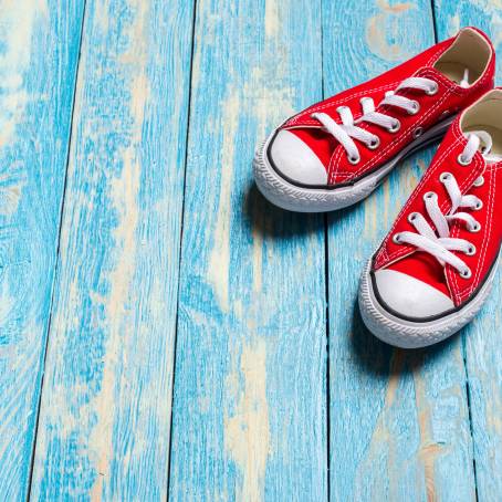 Retro Red Sneakers on a Blue Wooden Background Detailed Close Up of Classic Vintage Footwear