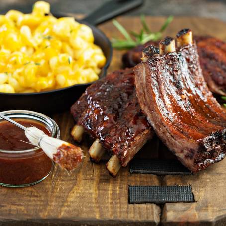 Savory Grilled Ribs with Smoky Barbecue Sauce on a Carving Board