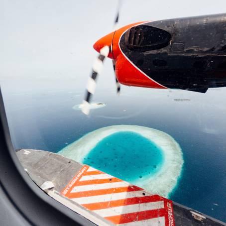 Seaplane Approaching Tropical Maldives Island Aerial View